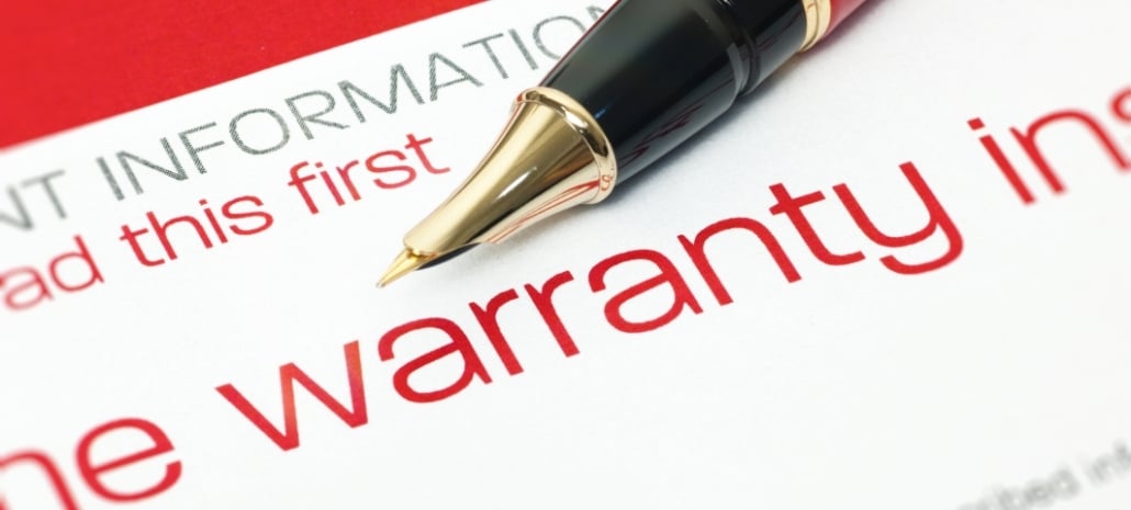 Warranty document with pen, representing the lifetime manufacturer's warranty provided with breast implants