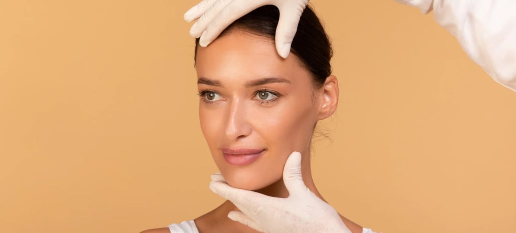 Doctor examining a patient's face during a consultation for nose surgery