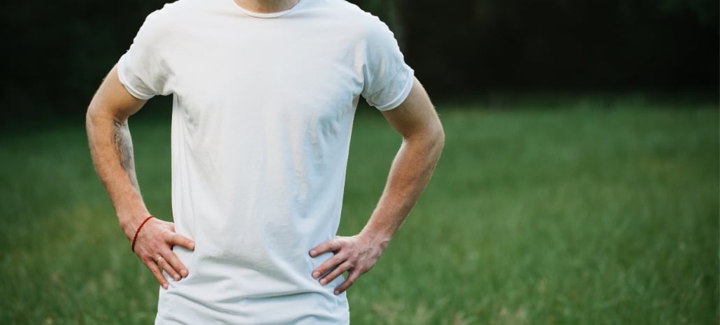 Confident man with hands on hips standing outdoors, reflecting the goal of a natural, restored chest contour after gynaecomastia surgery