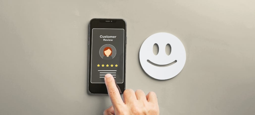 Smartphone showing a five-star customer review, representing patient feedback on plastic surgeons